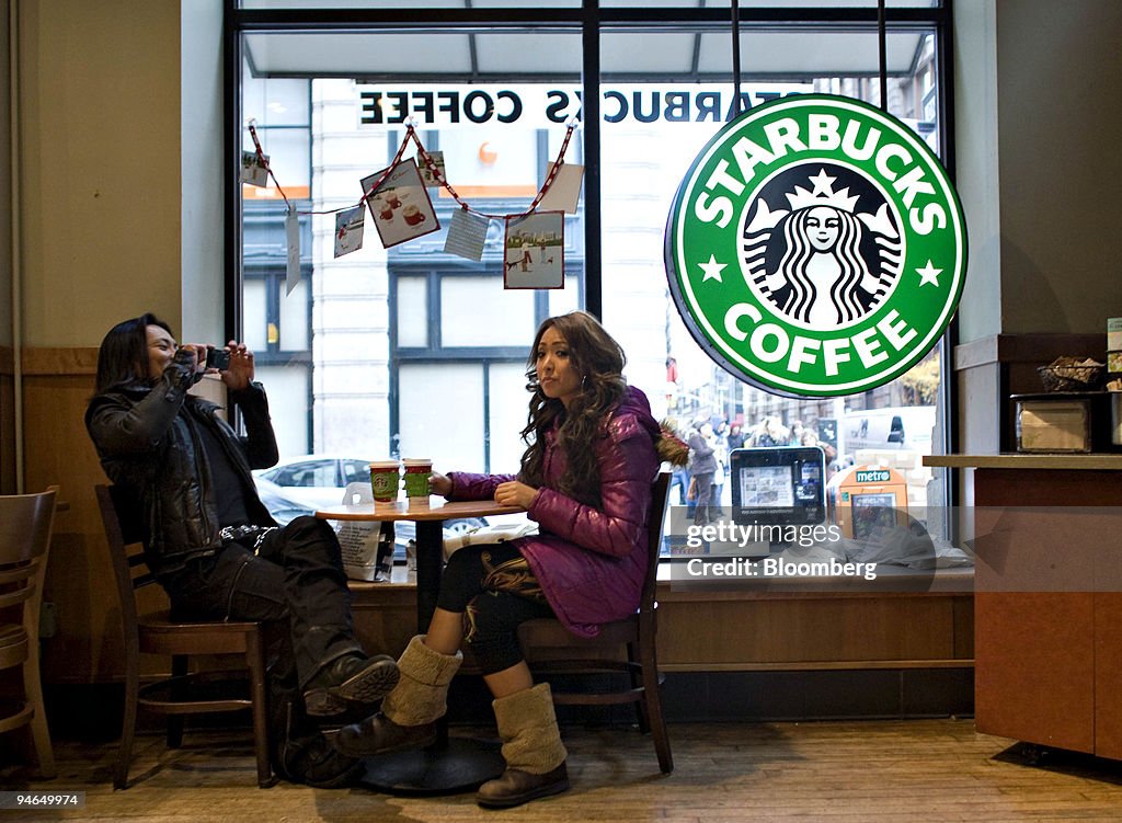 Patrons sit inside a Starbucks in New York, U.S., on Friday,