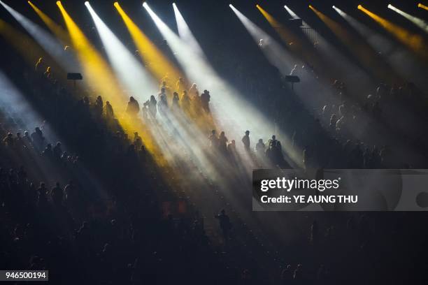 Spectators sit on the stands during a light show of the closing ceremony of the 2018 Gold Coast Commonwealth Games at the Carrara Stadium on the Gold...