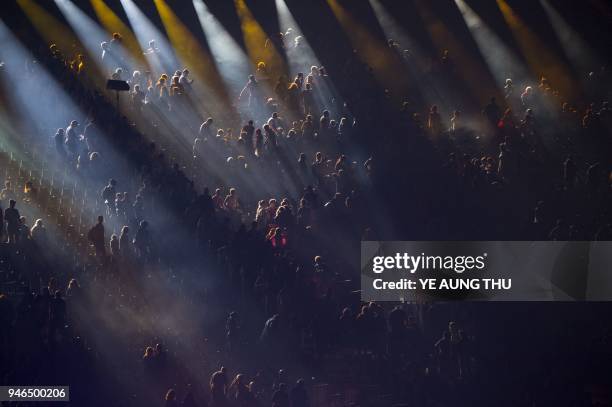 Spectators sit on the stands during a light show of the closing ceremony of the 2018 Gold Coast Commonwealth Games at the Carrara Stadium on the Gold...