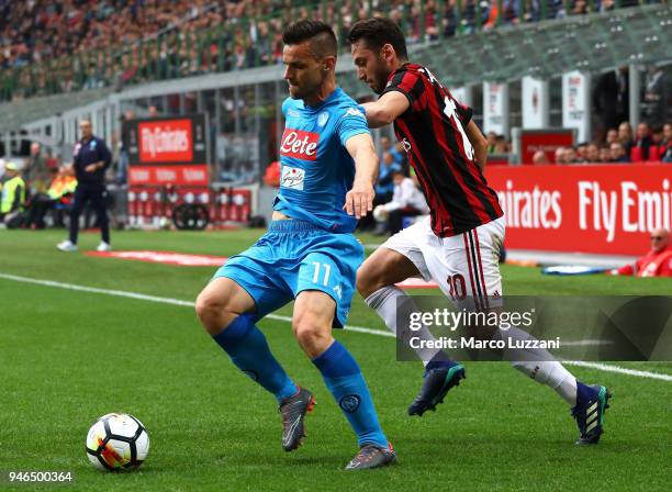 Christian Maggio of SSC Napoli competes for the ball with Hakan Calhanoglu of AC Milan during the serie A match between AC Milan and SSC Napoli at...