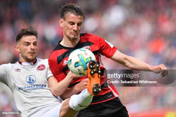 Tim Leibold of Nuernberg and Stefan Kutschke of Ingolstadt compete for the ball during the Second Bundesliga match between FC Ingolstadt 04 and 1. FC...