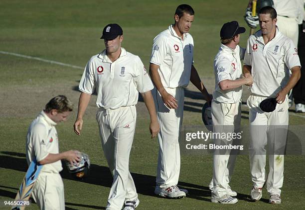 England captain Andrew Flintoff, second left, leaves the field with teammates Ashley Giles, third from right, Ian Bell, second from right, Kevin...