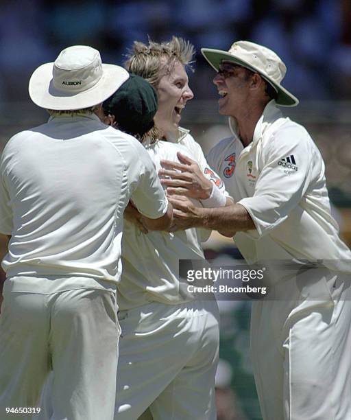 Brett Lee, bowling for Australia, celebrates with teammates Shane Warne, left, Adam Gilchrist, second left, and Matthew Hayden, right, after claiming...
