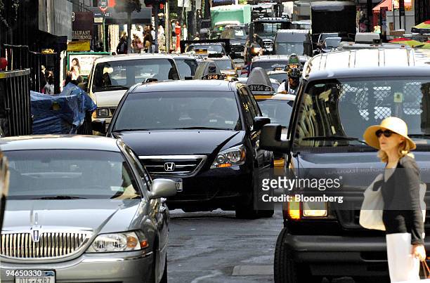 Woman waits for traffic to clear in order to cross 60th Street on Park Avenue in New York, on Aug. 14, 2007. New York City will receive $354 million...