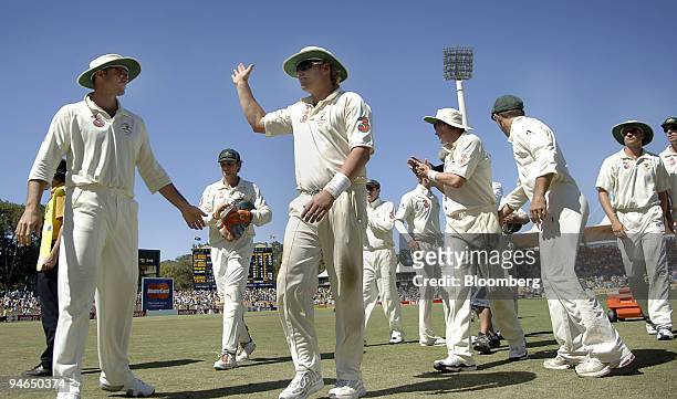 Shane Warne, bowling for Australia, salutes the crowd as he leaves the field with his team mates after taking 4 wickets from England on day 5 of the...