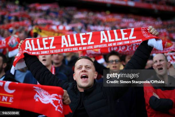 Liverpool fan holds his 'Allez Allez Allez' scarf aloft as he cheers his team on during the Premier League match between Liverpool and AFC...