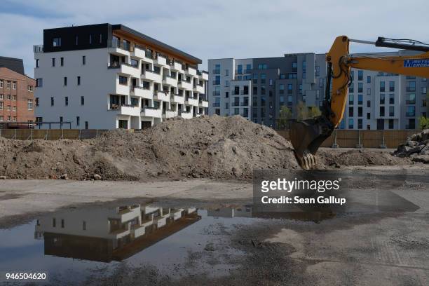 New apartment buildings stand next to a construction site in the eastern part of the city on April 15, 2018 in Berlin, Germany. According to a...