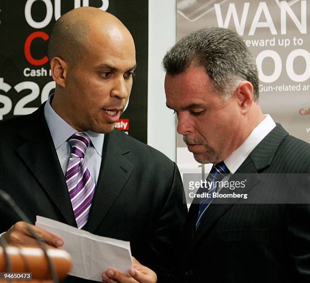 Newark, New Jersey Mayor Cory Booker confers with Police Director Garry McCarthy at a news conference to introduce a new Law Enforcement Leadership...