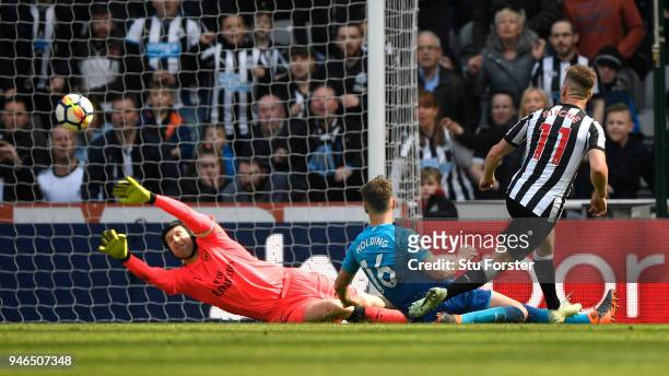 Matt Ritchie of Newcastle United scores his sides second goal past Petr Cech of Arsenal while being challenged by Rob Holding of Arsenal during the...