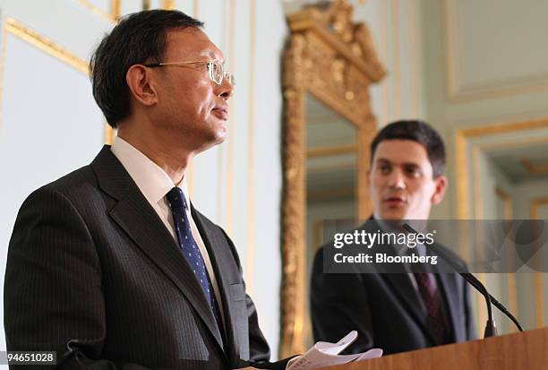 Yang Jiechi, left, the Chinese foreign minister, listens as David Miliband, the U.K. Foreign secretary, speaks during a press conference at Carlton...