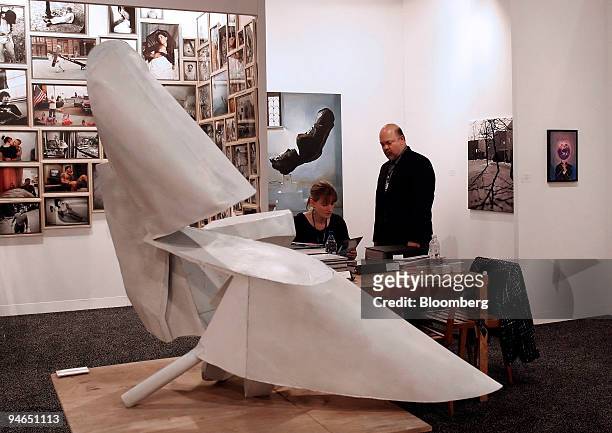 Julia, left, and Bennett Roberts of Roberts & Tilson speak near "Untitled " by Thomas Kiesewetter, a 2007 bronze sculpture measuring 36 x 48 x 24...