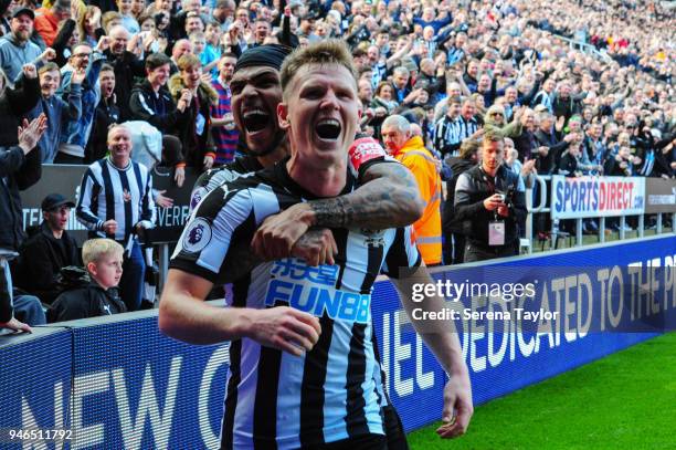 Matt Ritchie of Newcastle United celebrates with teammate DeAndre Yedlin after he scores Newcastle's second goal during the Premier League match...