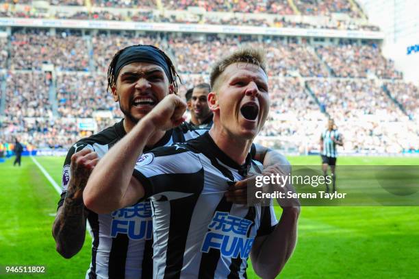 Matt Ritchie of Newcastle United celebrates with teammate DeAndre Yedlin after he scores Newcastle's second goal during the Premier League match...