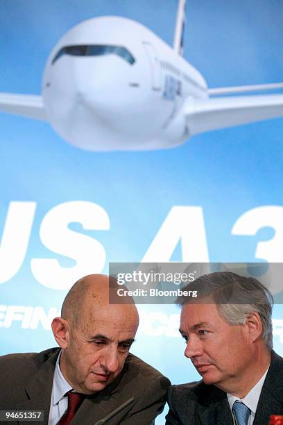 Louis Gallois, president and chief executive officer of Airbus SAS, left speaks with John Leahy, chief operating officer customers, during a news...