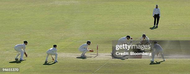 The Australian team's fielders gather as Ian Bell, batting for England, plays a stroke on Day 4 of the second Ashes Test match at the Adelaide Oval...