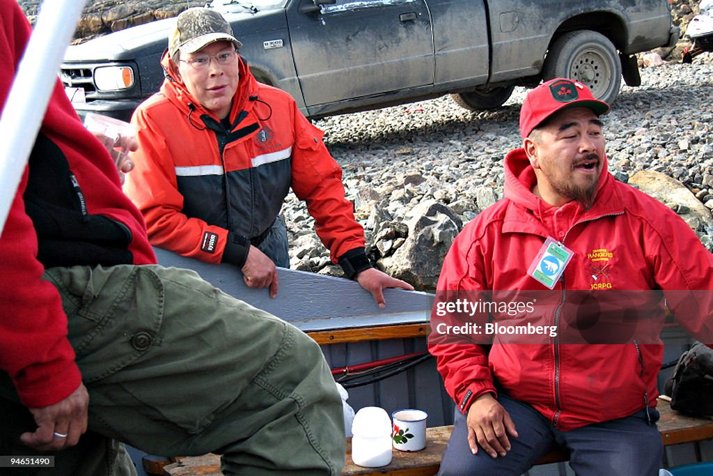 Canadian Ranger Pitseolak Alainga, right, speaks with collea