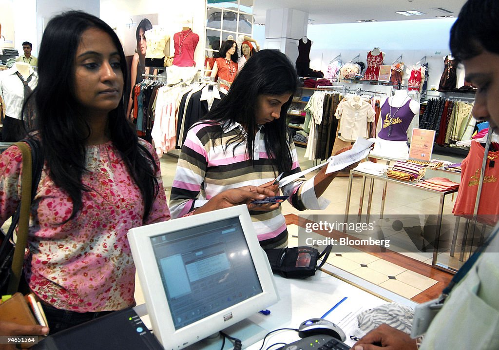A woman pays for purchases at a mall in Mumbai, India, on Th