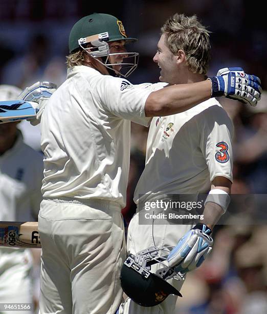 Michael Clarke, right, batting for Australia, celebrates with batting partner Shane Warne after reaching 100 runs on day 4 of the second Ashes Test...