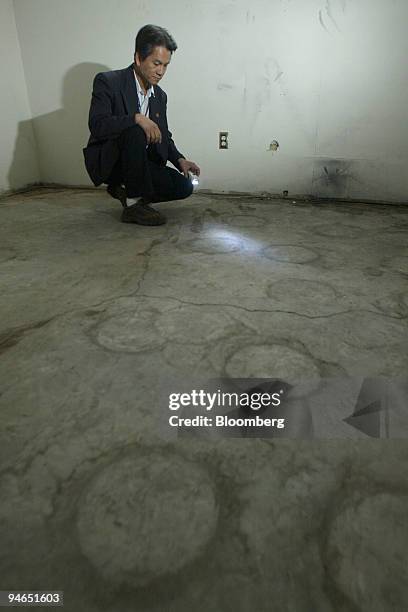Dee Nguyen, realtor, is pictured inside this home in the suburb of Sundance, in Calgary, Alberta, Canada, Wednesday, April 26, 2006. Circles on the...