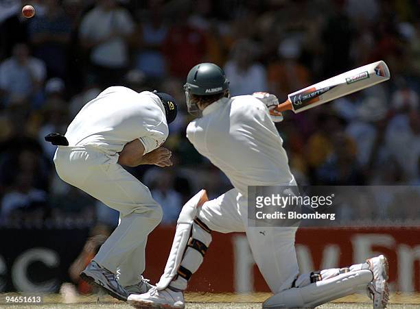 Adam Gilchrist, right, batting for Australia, slams a ball past the head of England fielder Alastair Cook on day 4 of the second Ashes Test match at...