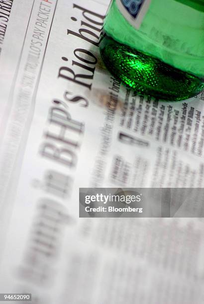 Water bottle sits on top of a newspaper with a headline on BHP Billiton Ltd.'s takeover bid for Rio Tinto Group, in Melbourne, Australia, on...