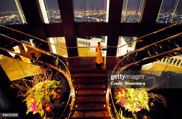 The staircase leading to the Sirocco and Mezzaluna restaurants 64 floors high over Bangkok with the skyline of Bangkok at night in Thailand on...