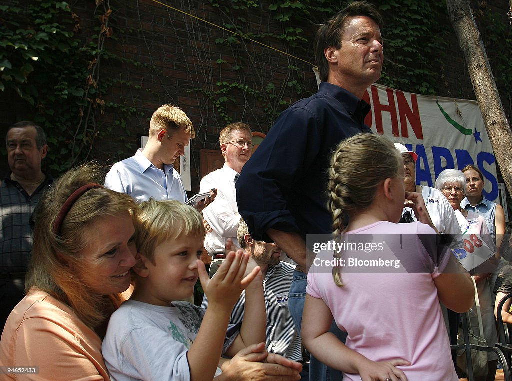 Democratic presidential candidate John Edwards stands with h