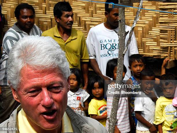 Bill Clinton, former U.S. President and the UN Secretary-General's special envoy for tsunami recovery, is watched by moken - or sea gypsy's - at...