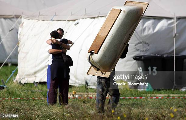 Protestor carries a bath near Heathrow airport where Climate Change protestors have set up camp at Heathrow near London, U.K., Monday, Aug. 13, 2007....