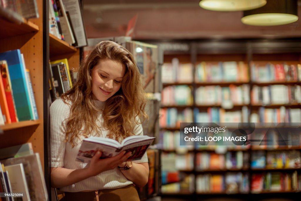 A young woman browses in a book store