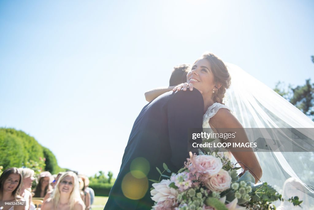 A bride and groom embrace on their wedding day