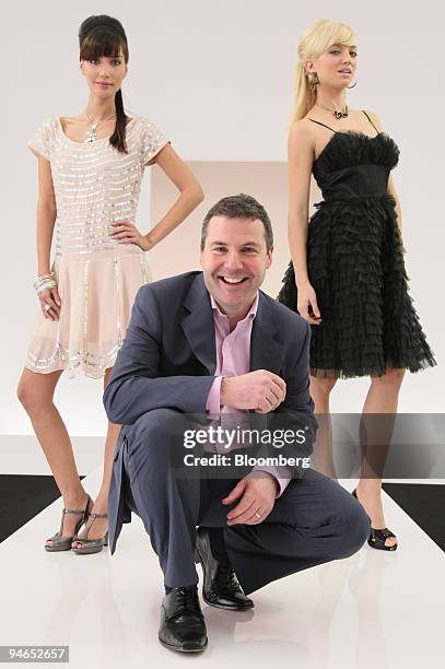 Nick Robertson, chief executive officer of internet fashion retailer Asos Plc., poses with models Mariel Booth and Elodie Bonis in London, U.K., on...