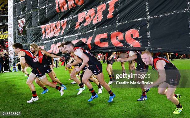 Essendon run through their banner during the round four AFL match between the Essendon Bombers and the Port Adelaide Power at Etihad Stadium on April...