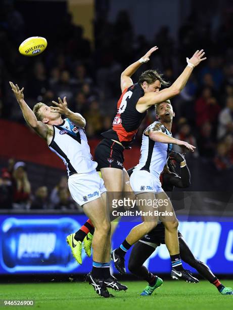 Tom Jonas of Port Adelaide attempts to mark behind Joe Daniher of the Bombers during the round four AFL match between the Essendon Bombers and the...