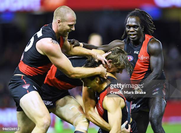 Mark Baguley of the Bombers celebrates a goal with Joe Daniher ,Jake Stringer and Anthony McDonald-Tipungwuti of the Bombers during the round four...