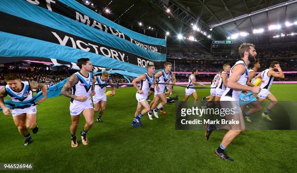 Port Adelaide run throught their banner during the round four AFL match between the Essendon Bombers and the Port Adelaide Power at Etihad Stadium on...