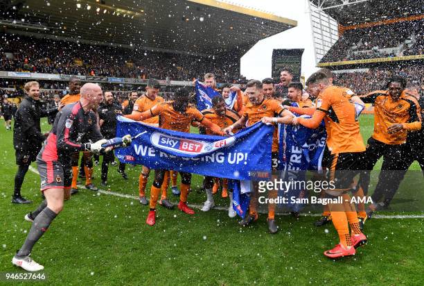 John Ruddy of Wolverhampton Wanderers spays players of Wolverhampton Wanderers with champagne as they celebrate promotion to the Premier League...