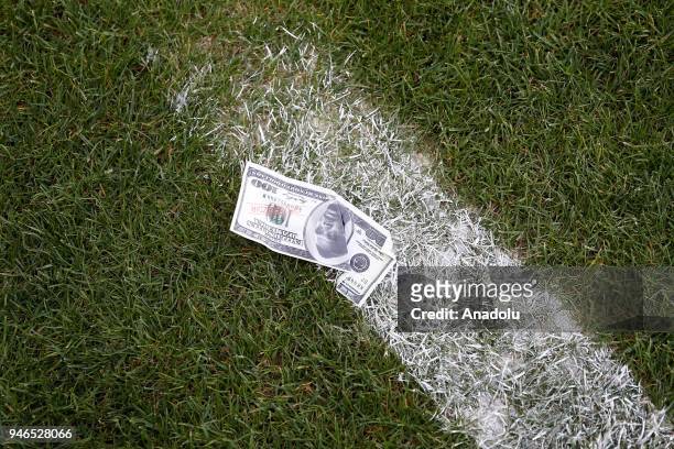 Fake 100 dollar bill with Eto'o photo is seen after a supporter of Antalyaspor threw it to protest "their former player" Eto'o, currently playing for...