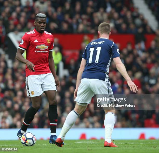 Paul Pogba of Manchester United in action with Chris Brunt of West Bromwich Albion during the Premier League match between Manchester United and West...