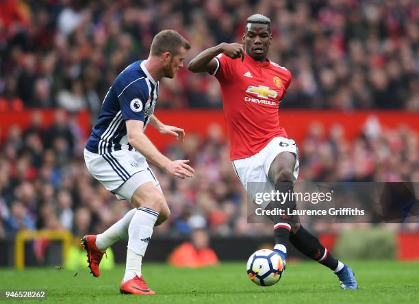 Paul Pogba of Manchester United is challenged by Chris Brunt of West Bromwich Albion during the Premier League match between Manchester United and...