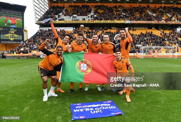 Players of Portugal and Wolverhampton Wanderers celebrate promotion to the Premier League during the Sky Bet Championship match between Wolverhampton...