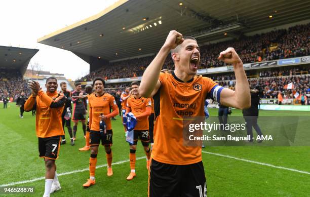 Conor Coady of Wolverhampton Wanderers celebrates promotion to the Premier League during the Sky Bet Championship match between Wolverhampton...