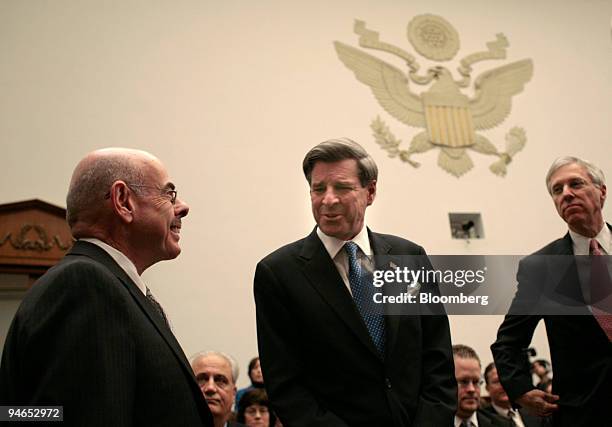 Paul Bremer center, Former Head, Coalition Provisional Authority, greets Chairman Henry Waxman , left, before the start of a House Oversight and...