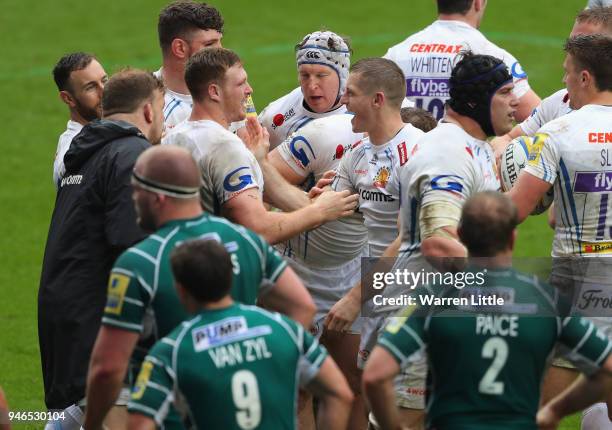 Sam Simmons of Exeter Chiefs is congratulated by his team mates after scoring a try during the Aviva Premiership match between London Irish and...