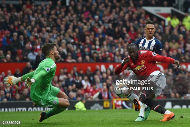 Manchester United's Belgian striker Romelu Lukaku has this shot saved by West Bromwich Albion's English goalkeeper Ben Foster during the English...