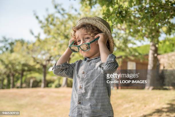 a young boy plays in the sunshine - boyhood film stock-fotos und bilder