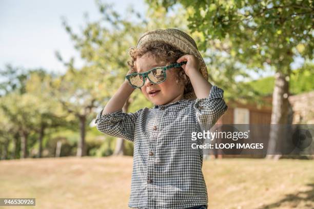 a young boy plays in the sunshine - boyhood film stock-fotos und bilder