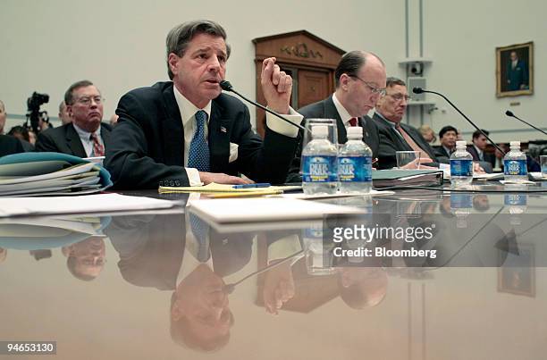 Paul Bremer, left at table, former head, Coalition Provisional Authority, testifies before a House Oversight and Government Reform Committee, as...
