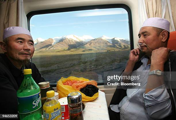 Muslim traders Ma Guocai, left, and his relative Ma Guohua both from Dunhuang ride on the Qinghai-Tibet Railway from Lhasa to conduct business on...