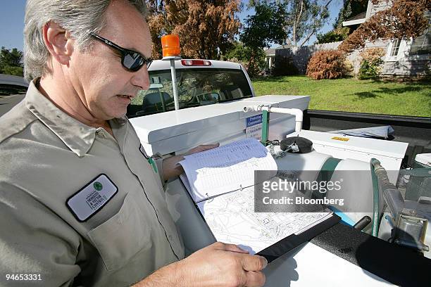 Field Technician Jeff Gay with the Sacramento-Yolo Mosquito and Vector Control District, looks over a map listing unmaintained swimming pools in...